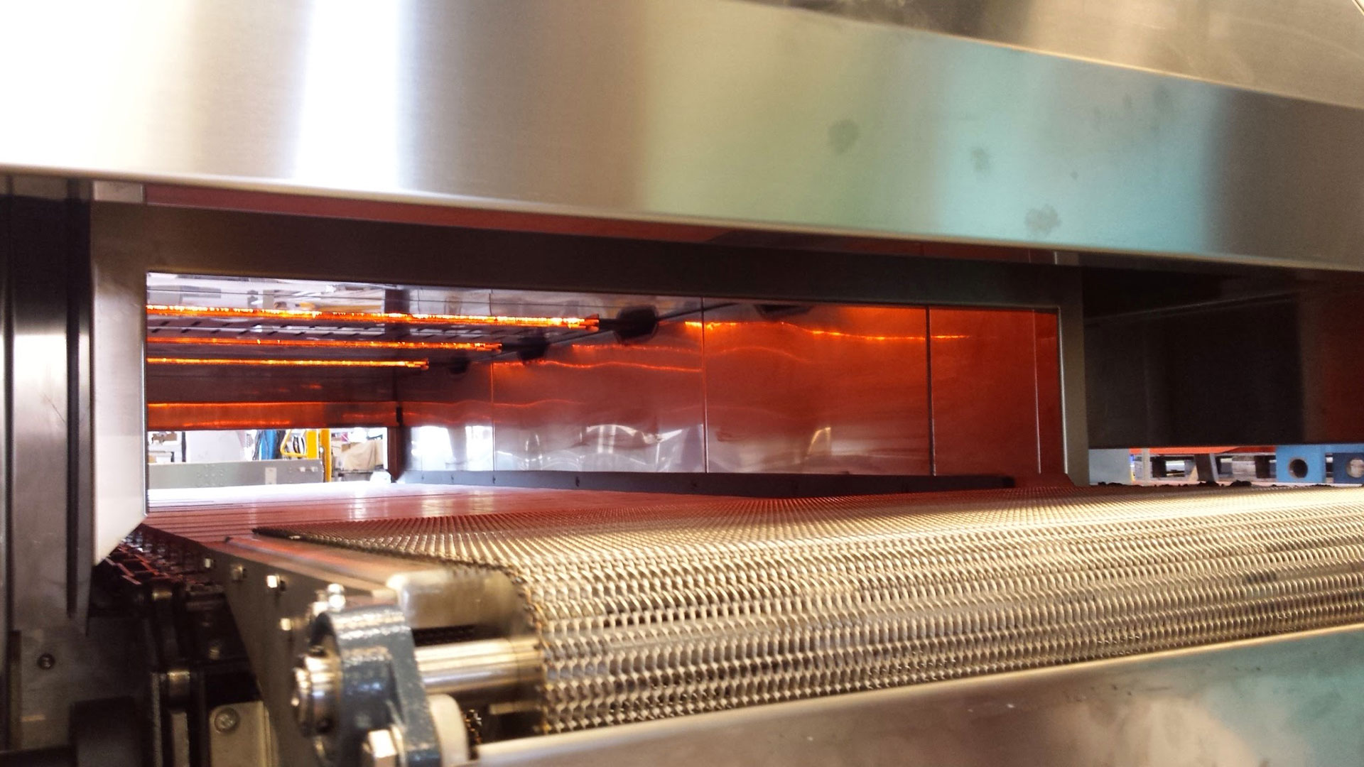 Burners for cooking food products in an industrial oven